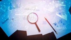 Corporate Finance Online Course - Magnifying glass and documents with analytics data lying on table