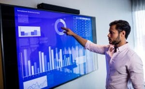 Online Course In Data Science - Businessman analyzing data with a touch screen in office