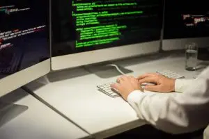 Online Courses In Python - programmer with computer screens Coding